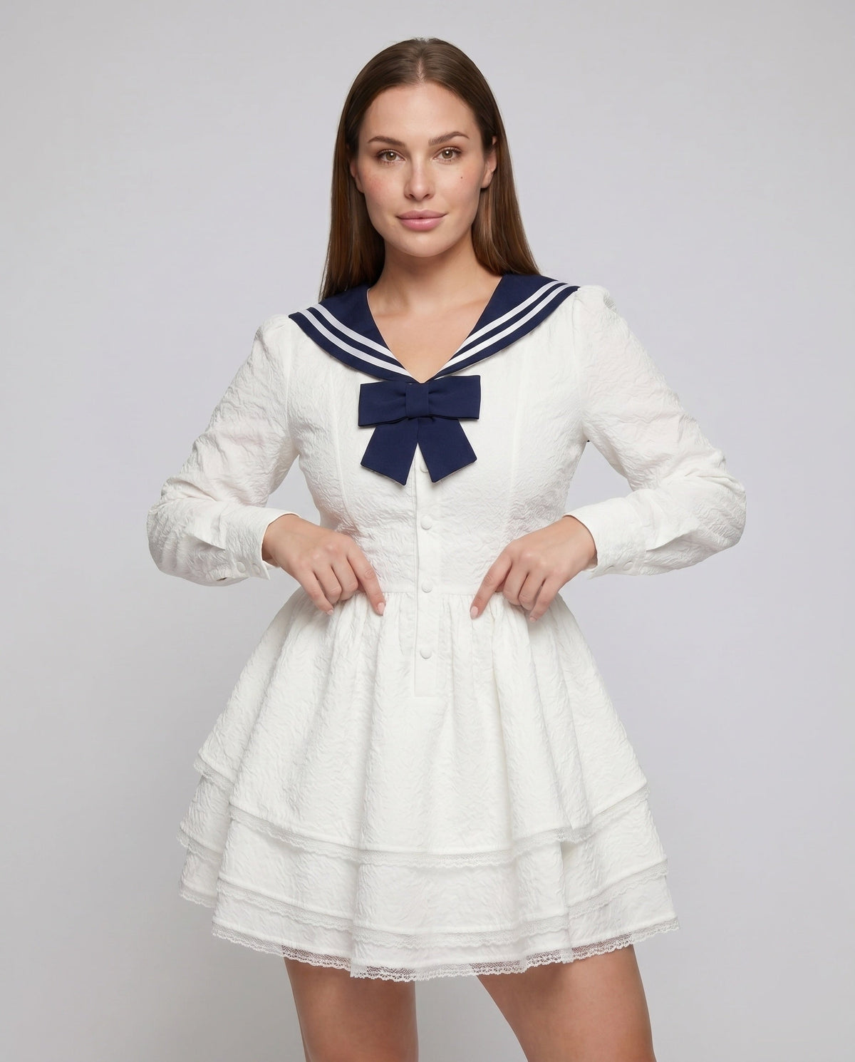 Women's nautical-inspired mini dress with wide skirt and continuous ruffle hem - upper body view