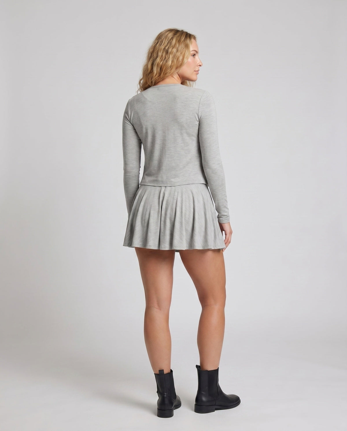 Women’s player dress with long sleeves and playful cut - back view
