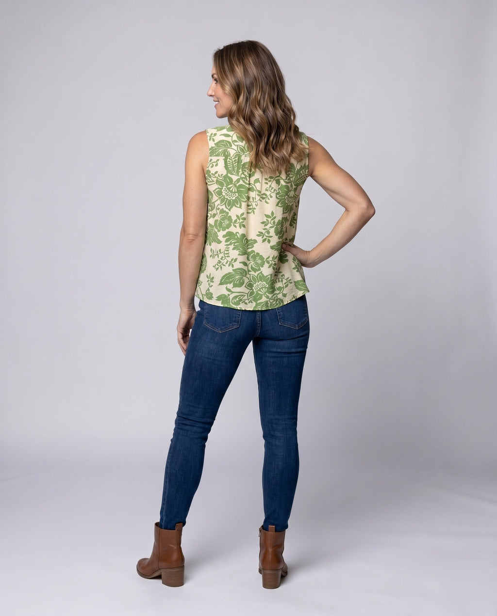 Women's sleeveless blouse shirt with playful ruffles and decorative neckline - back view