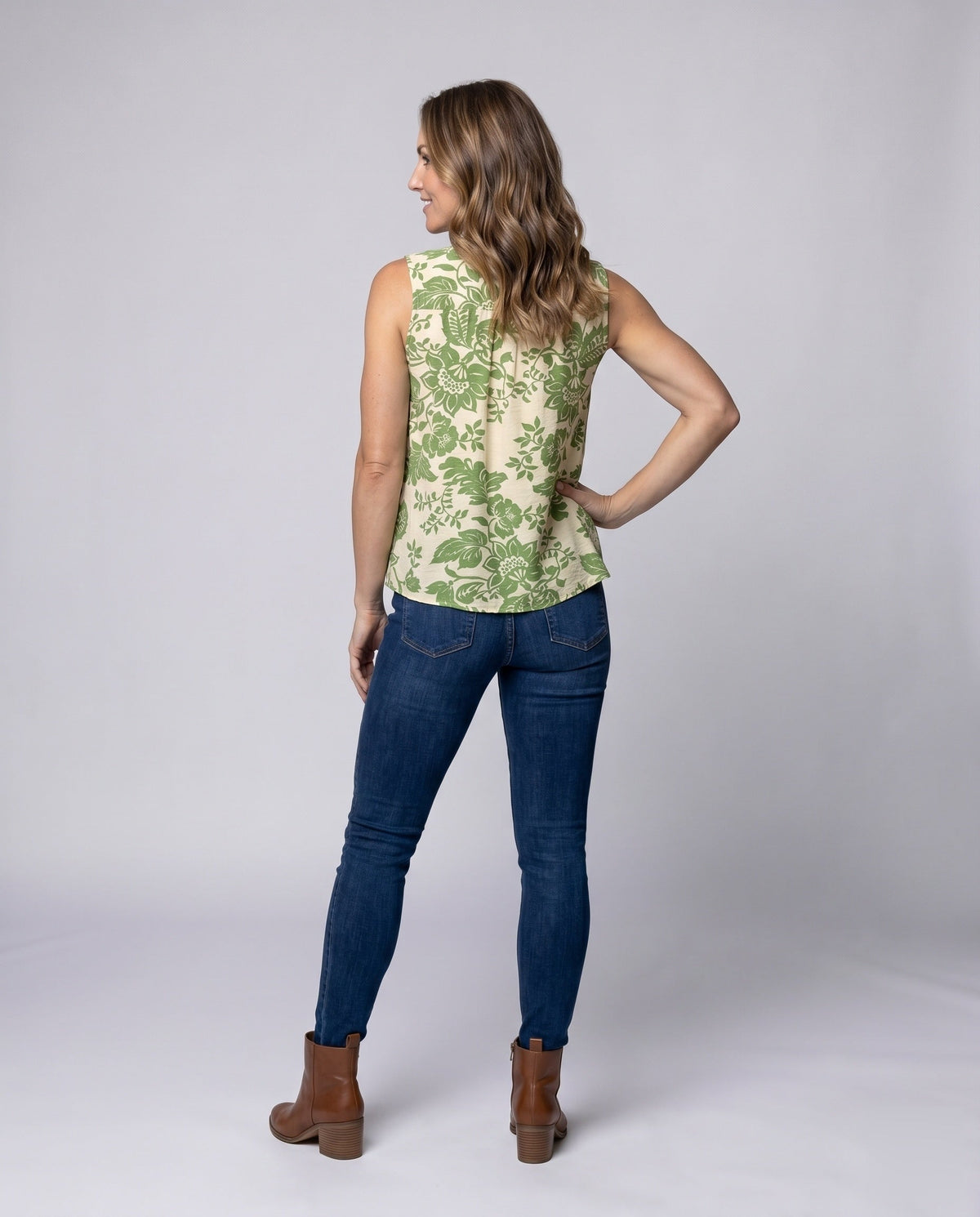 Women's sleeveless blouse shirt with playful ruffles and decorative neckline - back view