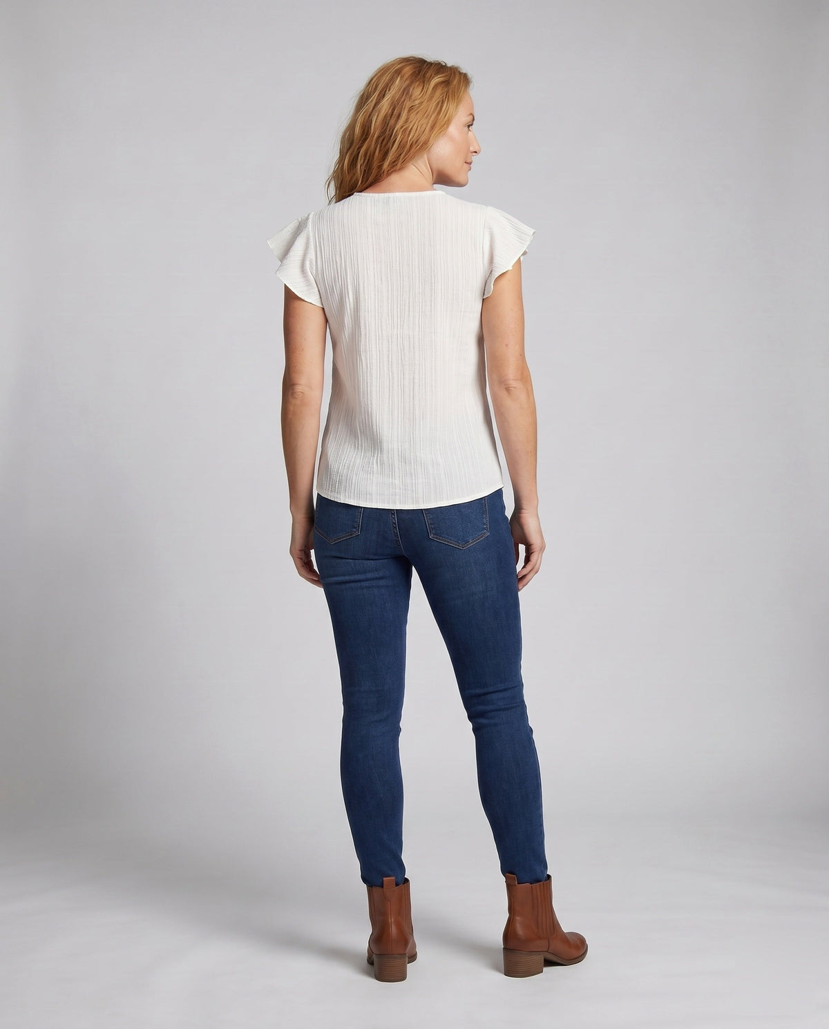 Women’s blouse top with colorful embroidery and ruffle details - back view