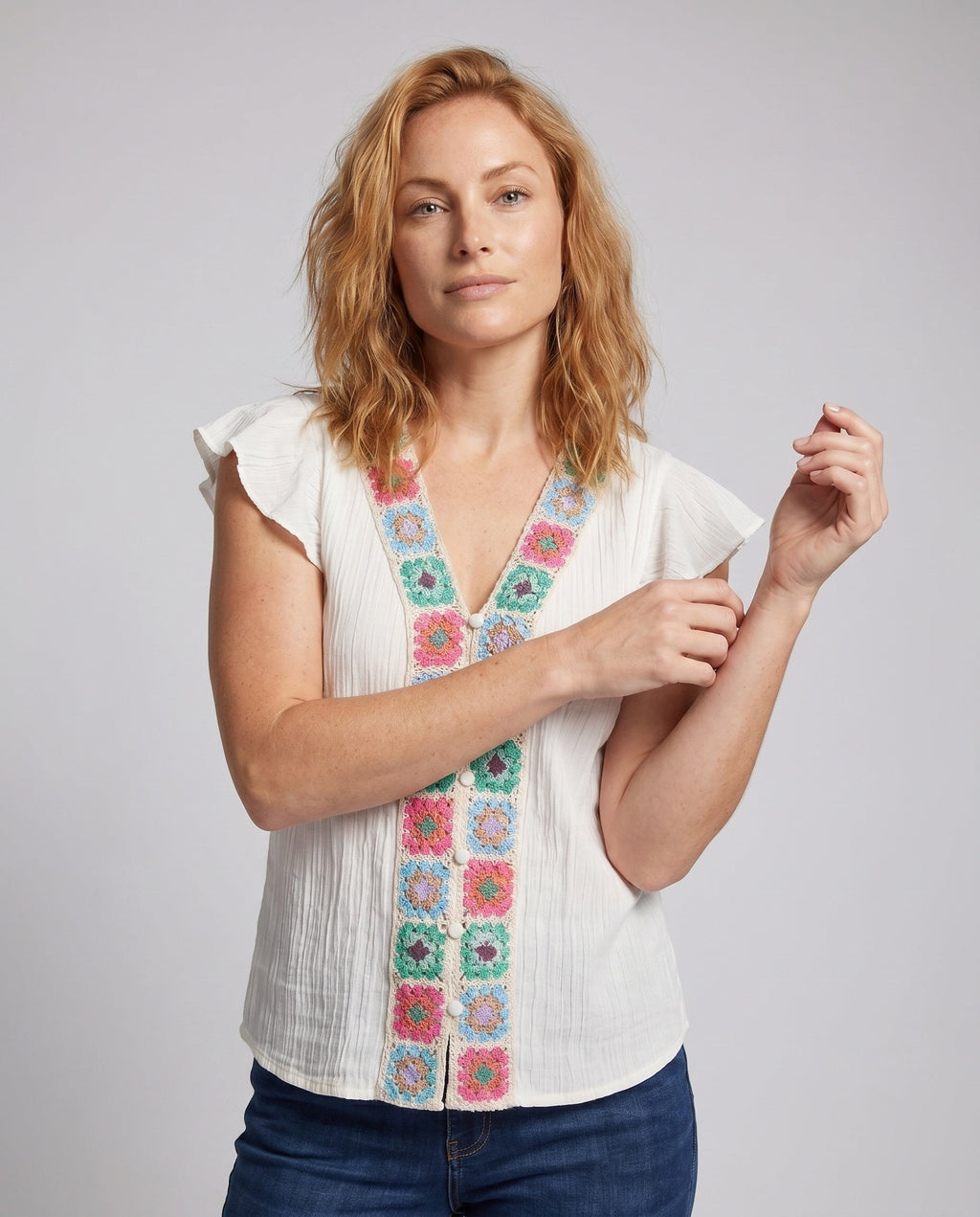 Women’s blouse top with colorful embroidery and ruffle details - upper body view