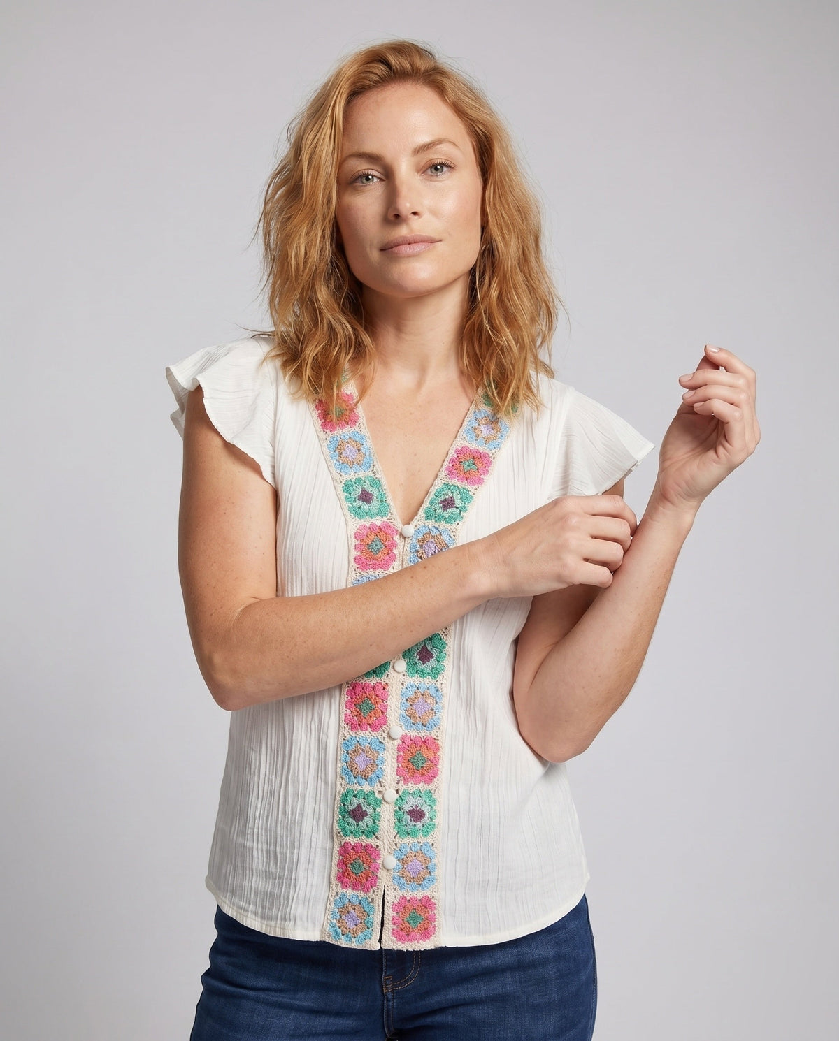 Women’s blouse top with colorful embroidery and ruffle details - upper body view