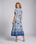 Women’s floral maxi dress with waist belt and elegant ruffle hem - back view