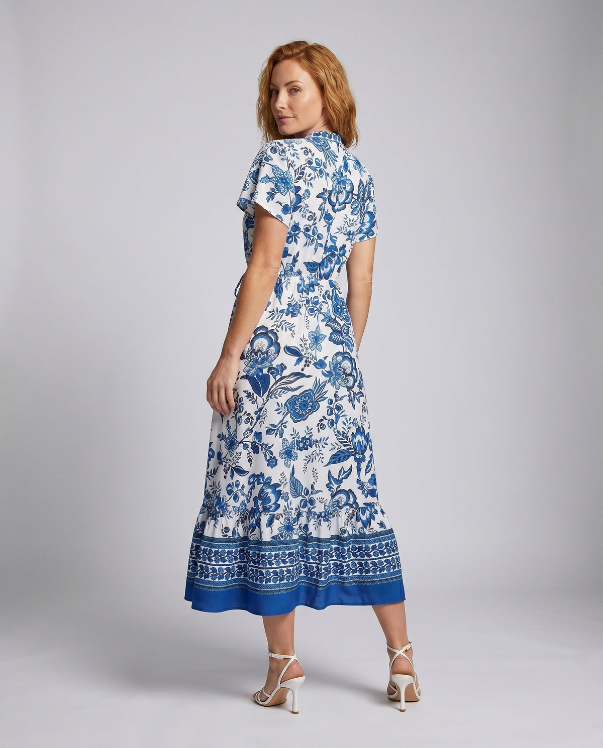 Women’s floral maxi dress with waist belt and elegant ruffle hem - back view