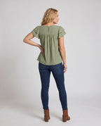 Women airy blouse shirt with ruffle details and polka dot pattern - back view