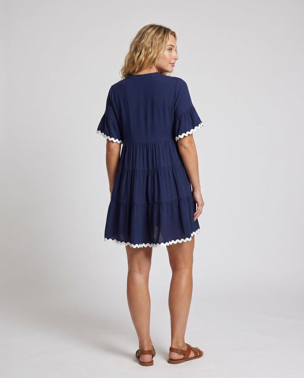 Women's airy dress with elegant ruffle details and button placket - back view