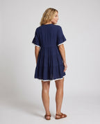 Women's airy dress with elegant ruffle details and button placket - back view