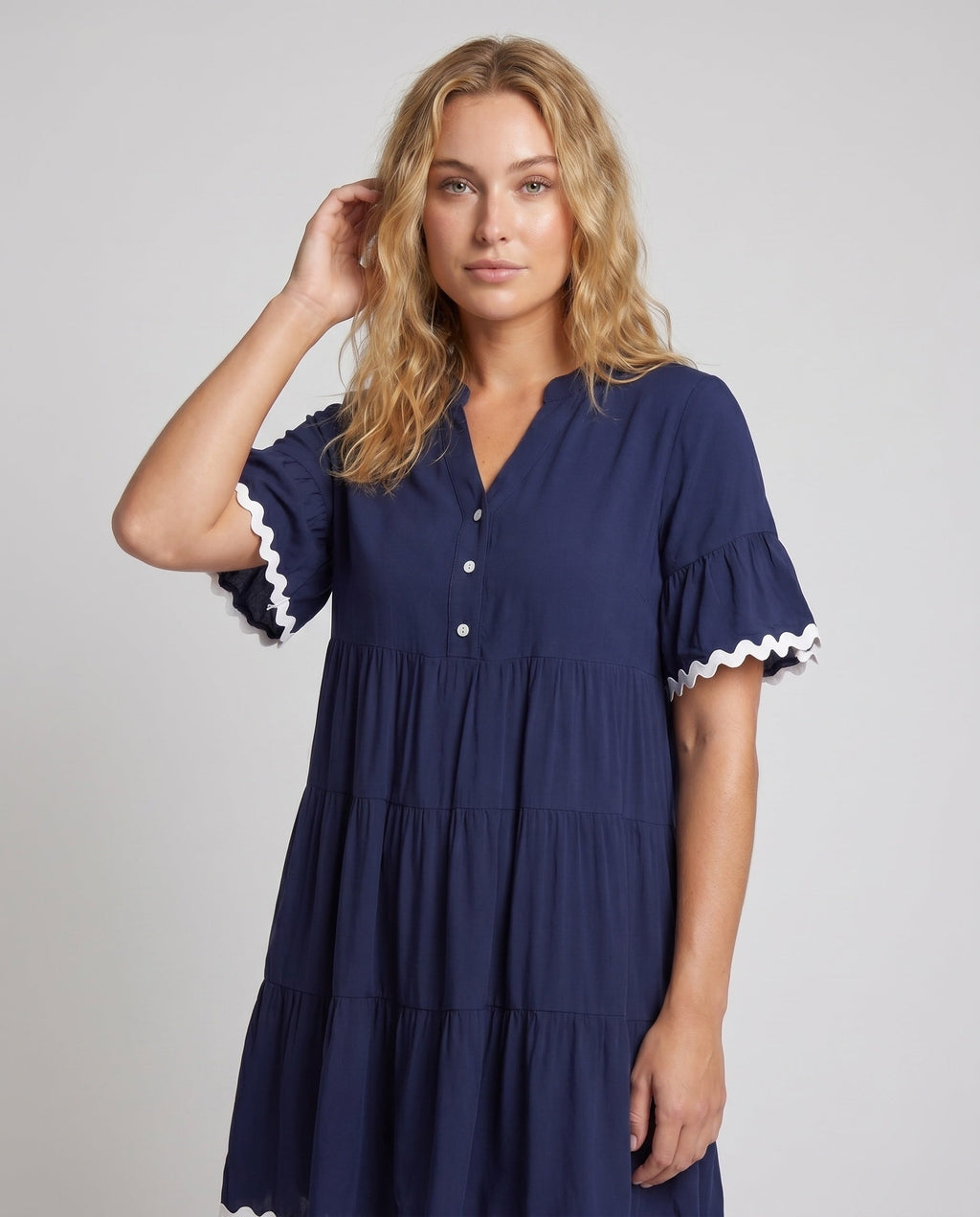 Women's airy dress with elegant ruffle details and button placket - upper body view