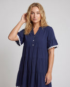 Women's airy dress with elegant ruffle details and button placket - upper body view