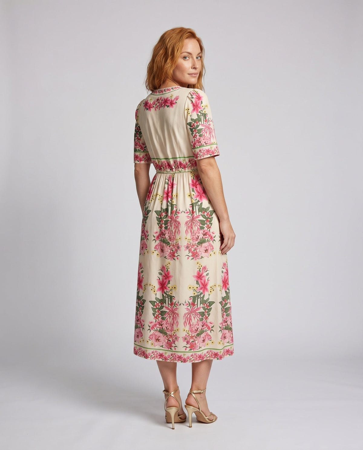 Women's maxi dress with playful floral design and elegant ruffle - back view