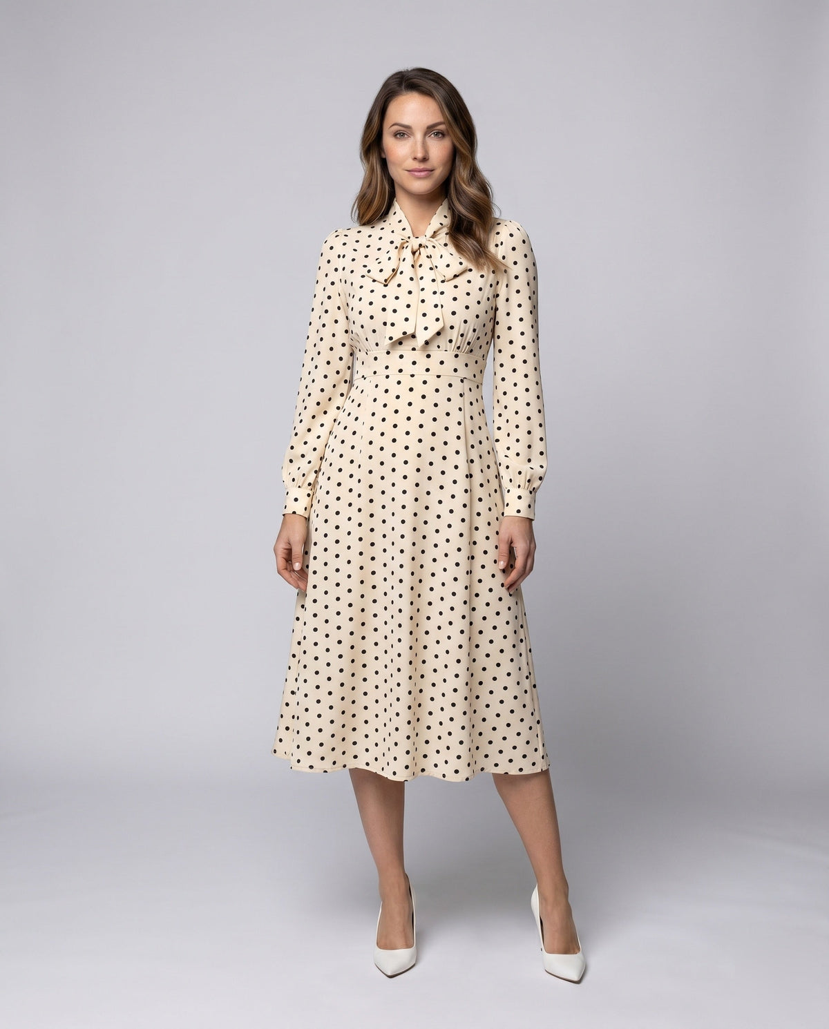 Women's midi dress with elegant bow collar and playful dots - front view