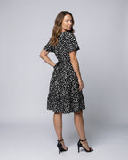 Women’s midi dress with flowing skirt and decorative polka dot pattern - back view