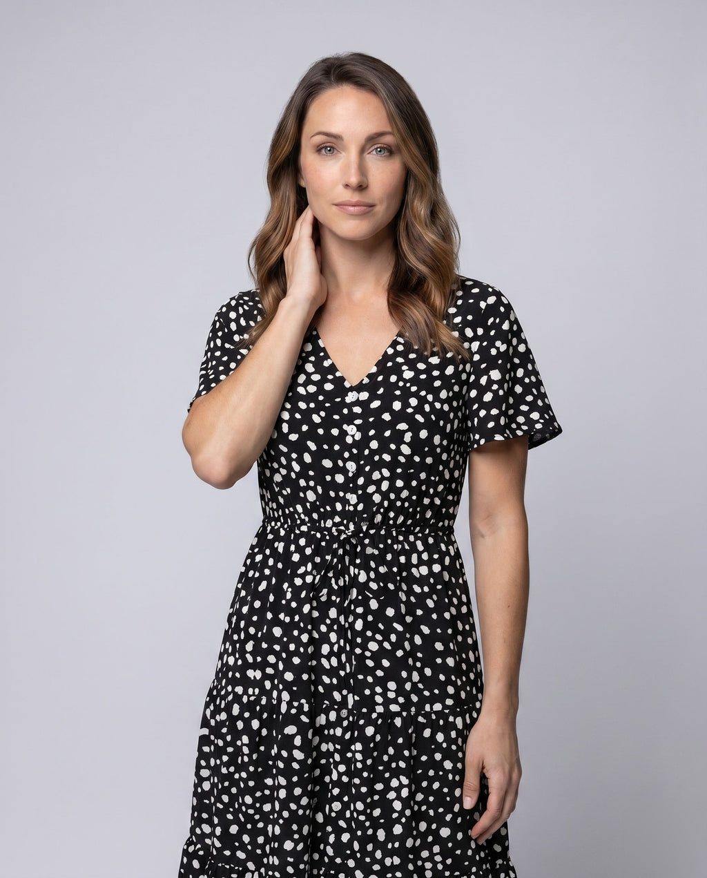 Women’s midi dress with flowing skirt and decorative polka dot pattern - upper body view