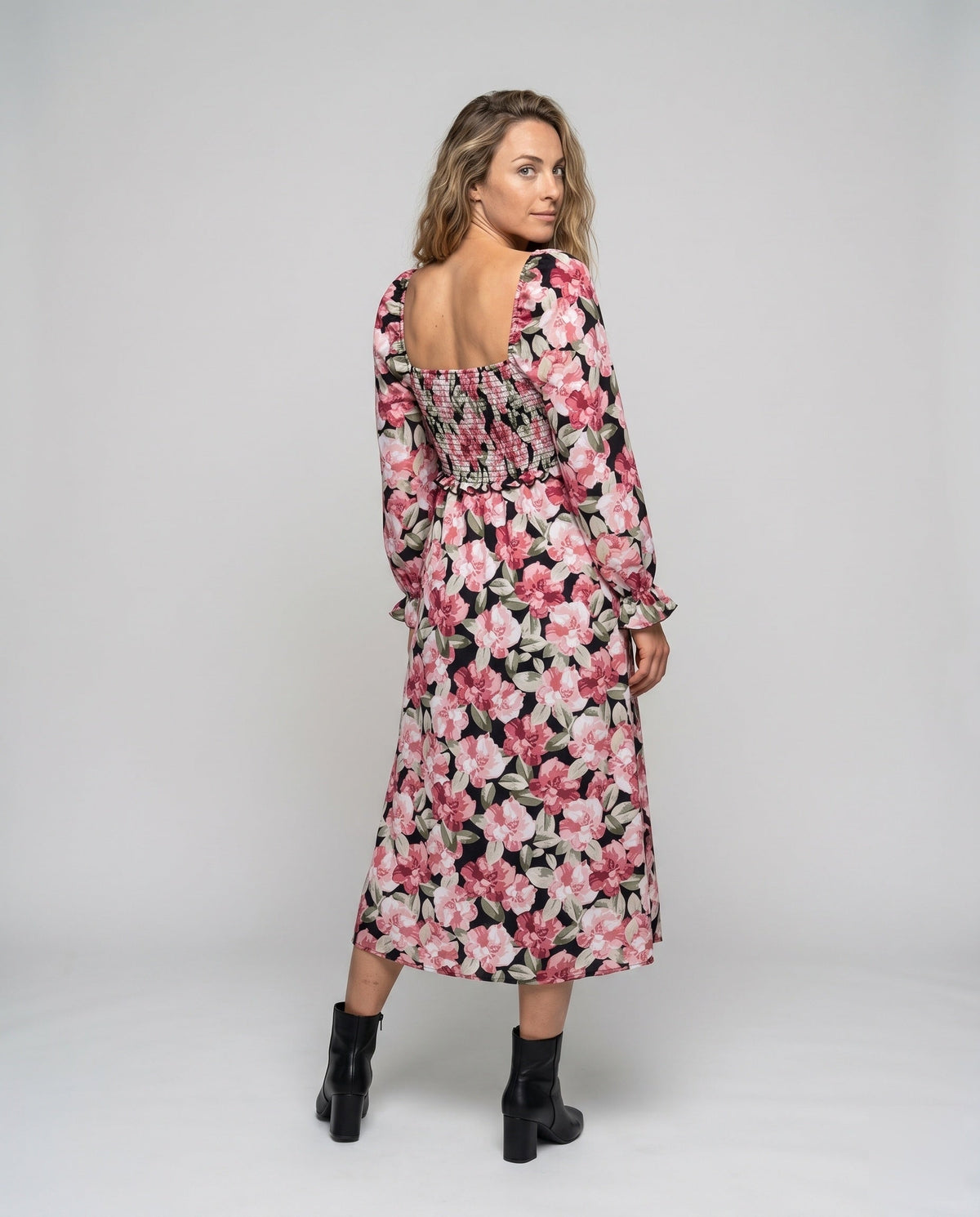 Women's midi dress with floral design and chic slit - back view