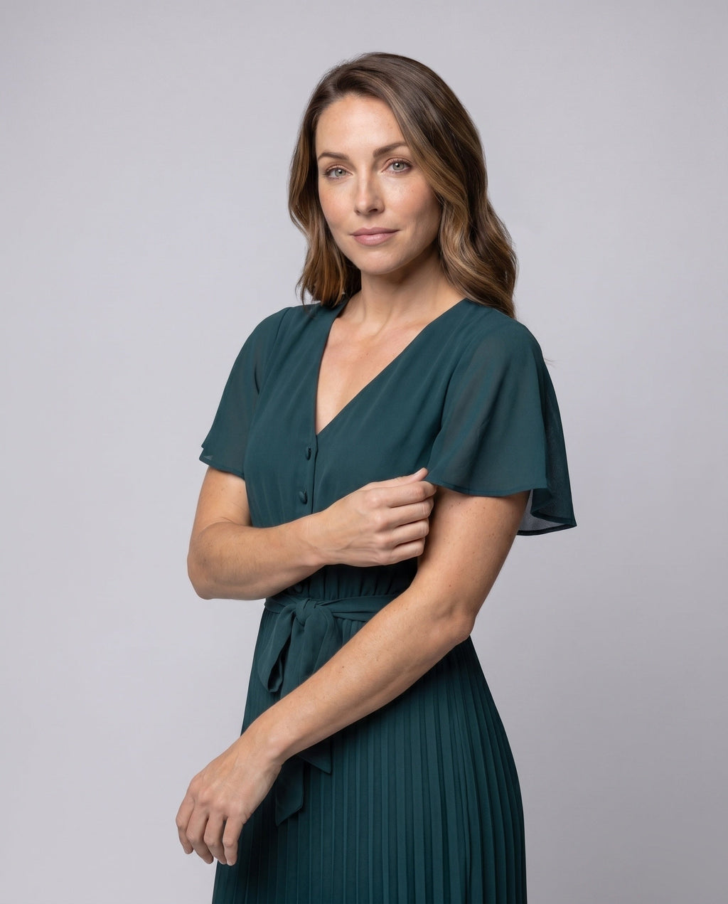 Women's pleated dress with V-neck and waist belt - upper body view