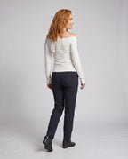 Women's blouse top with decorative bow accent and open shoulders - back view
