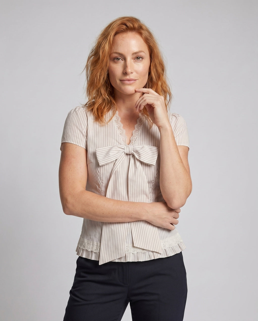 Women's blouse shirt with decorative bow design and fine ruffle details - upper body view