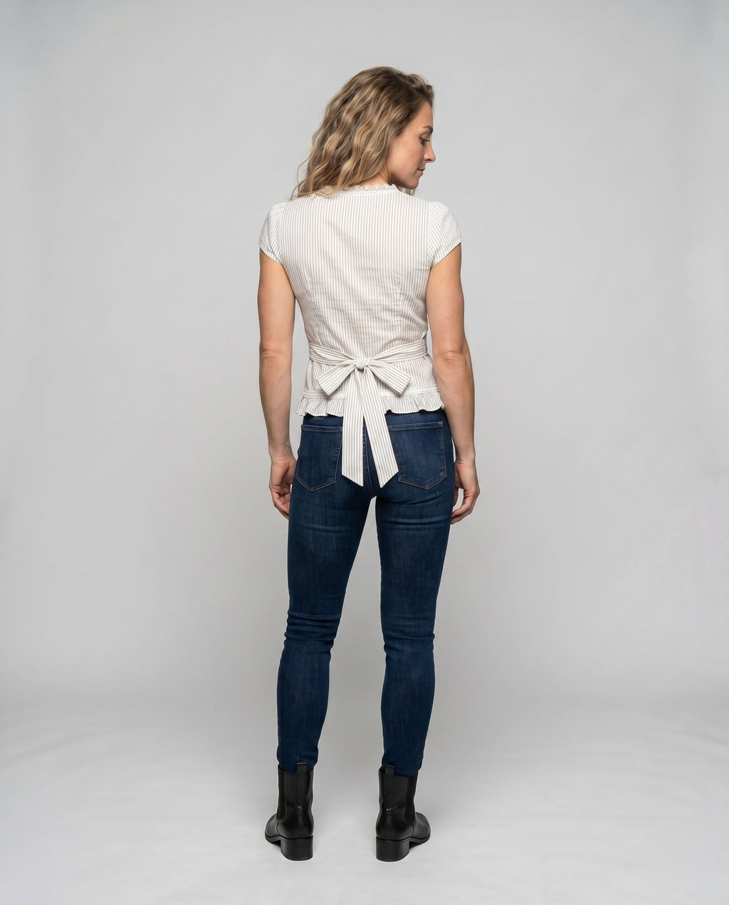 Women's blouse shirt with playful bow design and ruffle hem - back view