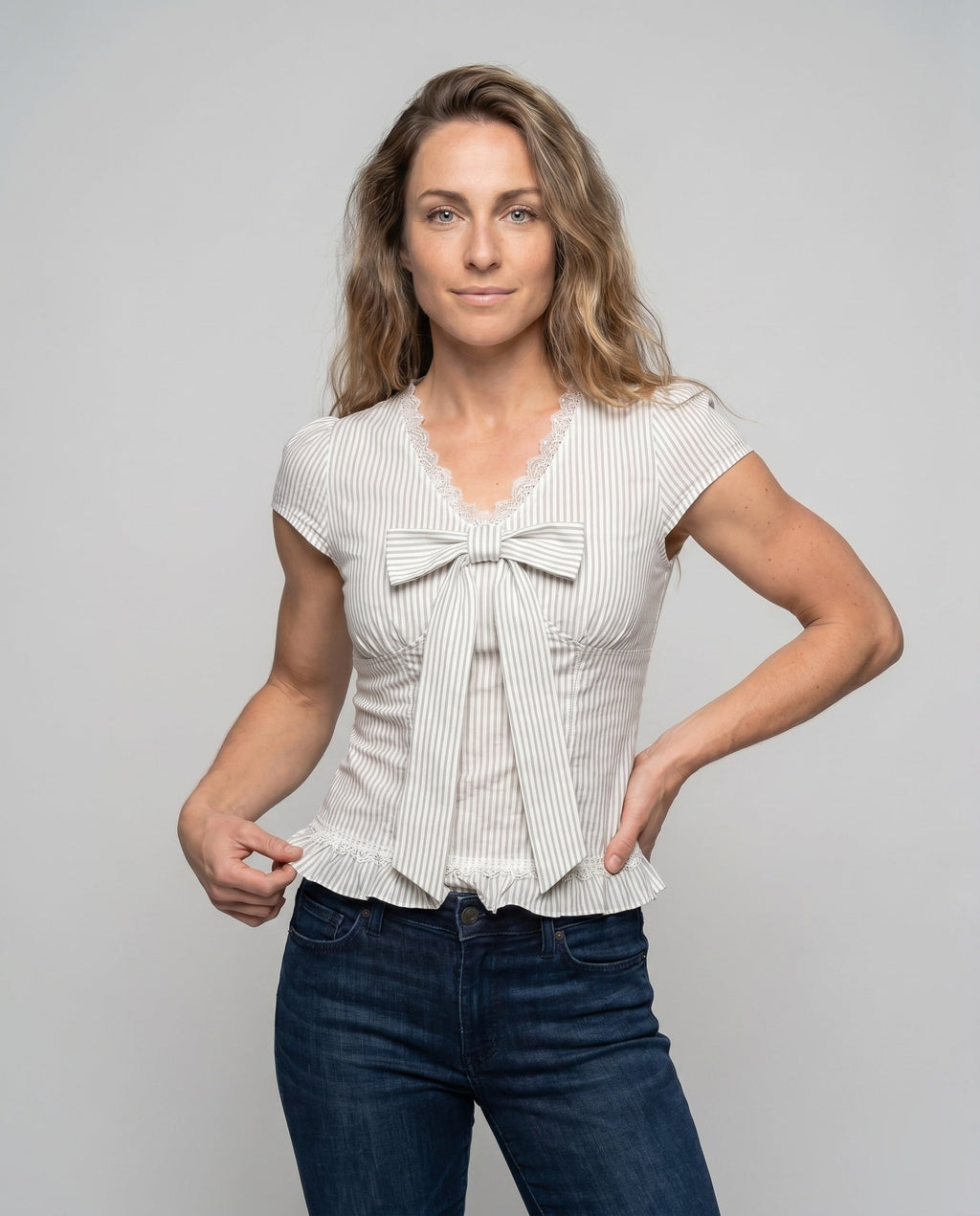 Women's blouse shirt with playful bow design and ruffle hem - upper body view