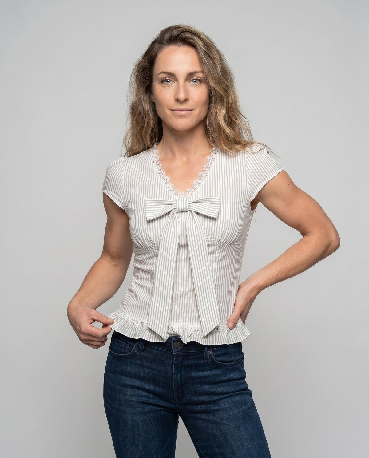 Women's blouse shirt with playful bow design and ruffle hem - upper body view