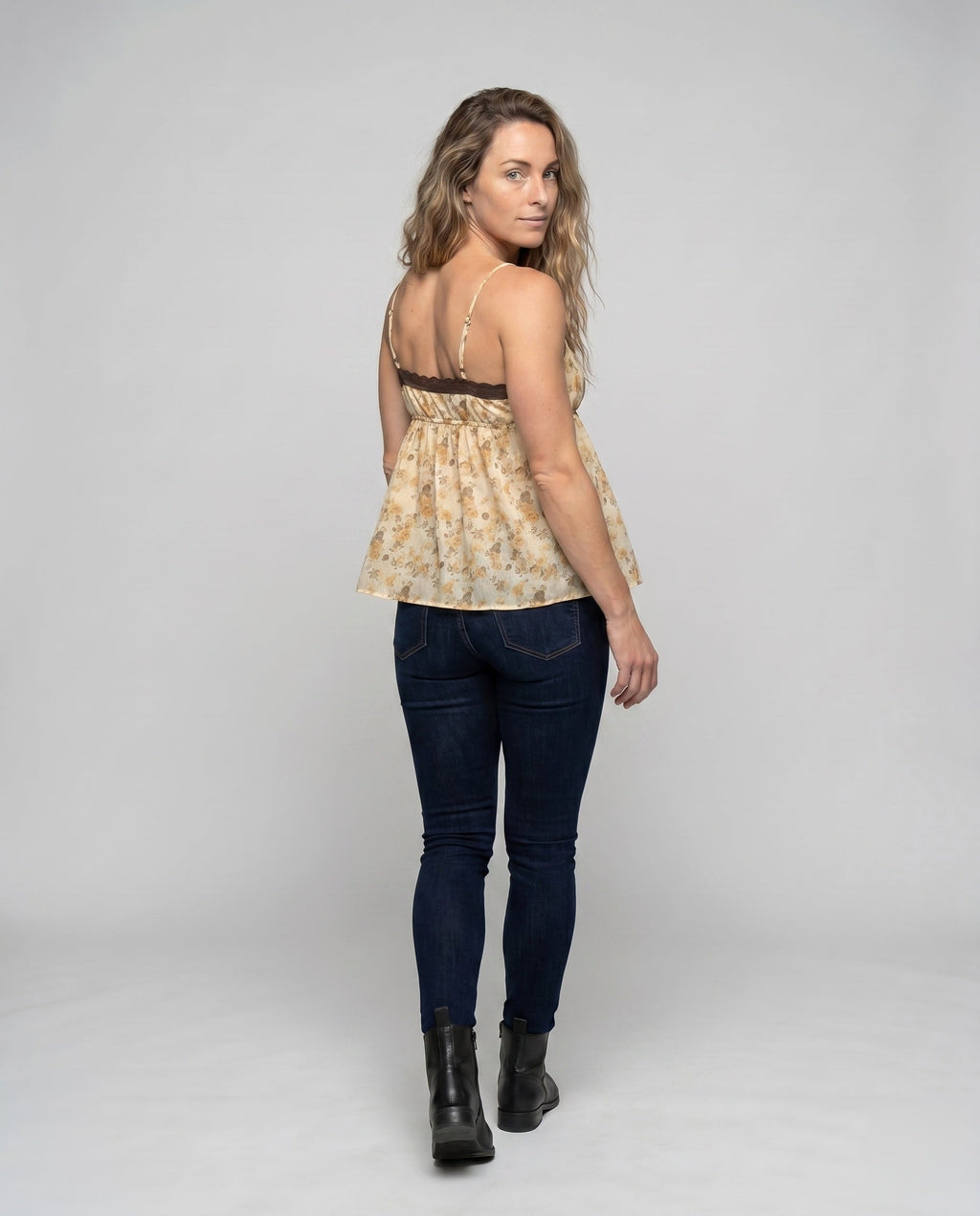 Women’s blouse top with floral accents and adjustable straps - back view
