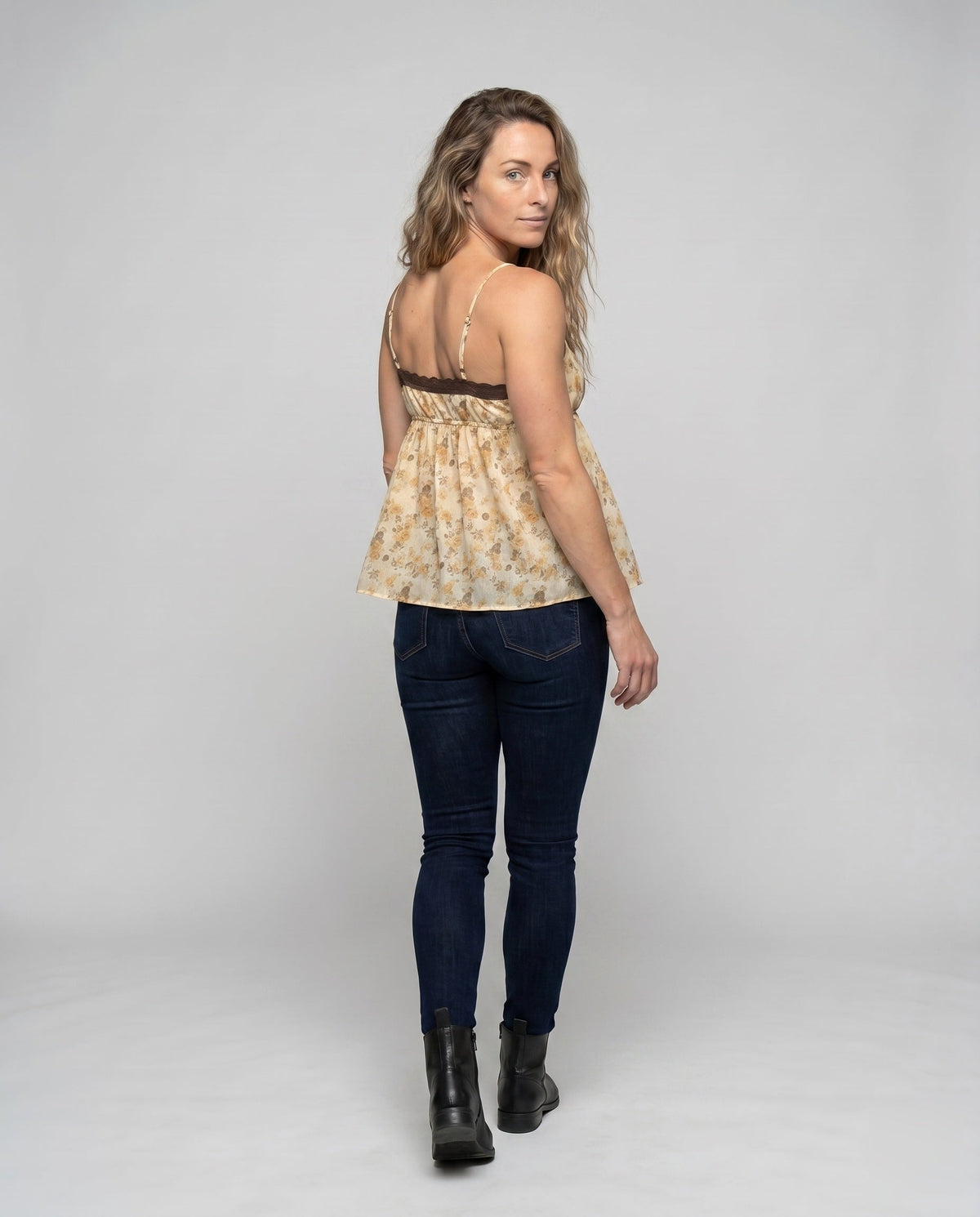 Women’s blouse top with floral accents and adjustable straps - back view