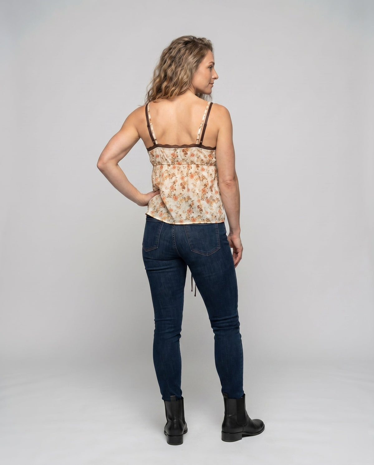 Women’s blouse top with playful floral pattern and decorative spaghetti straps - back view