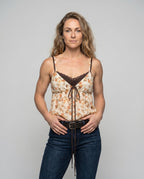 Women’s blouse top with playful floral pattern and decorative spaghetti straps - upper body view