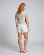 Women's casual blouse shirt with ruffle details and playful bow accent - back view