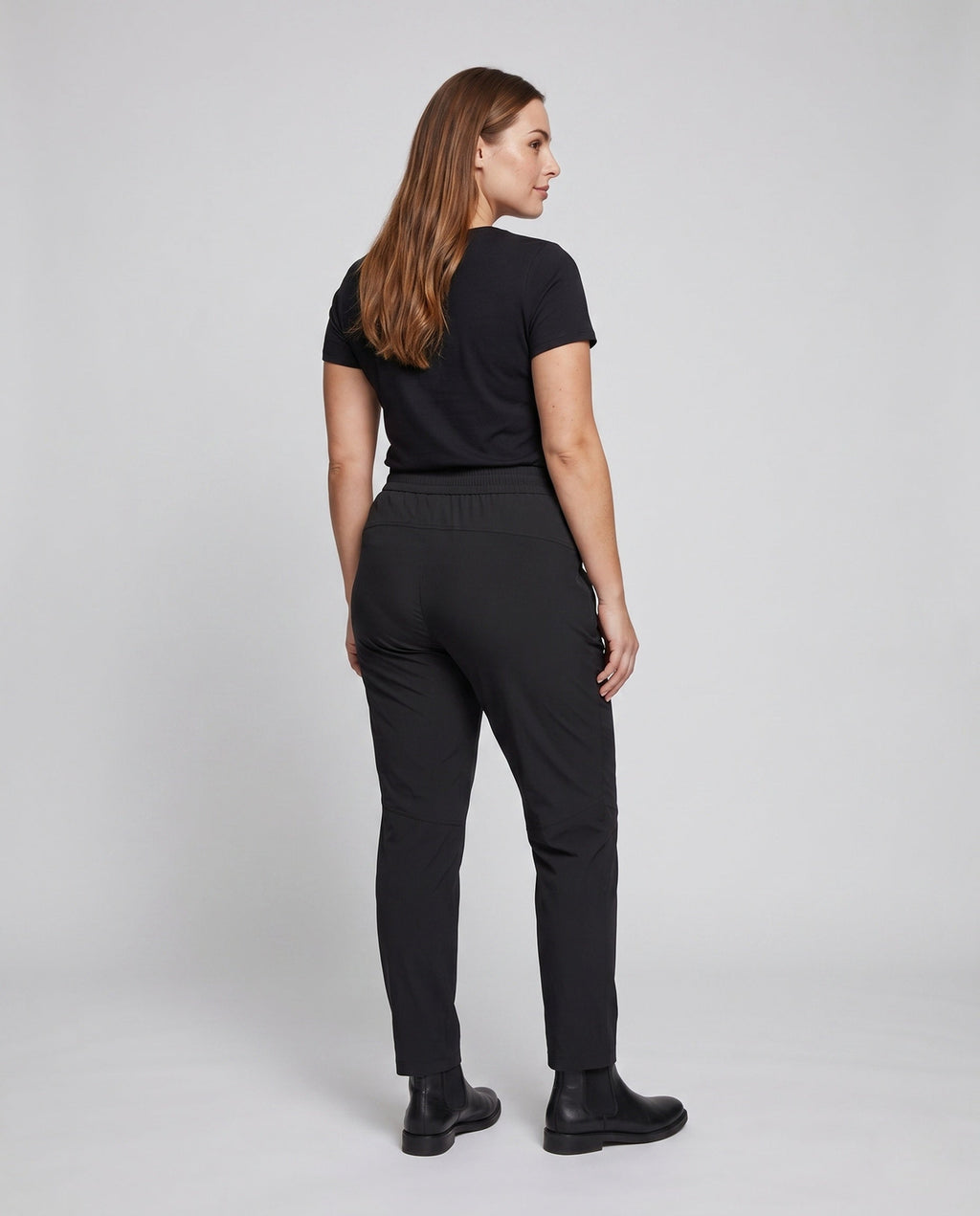 Women’s technical cargo pants with elastic waistband and practical zip pockets - back view