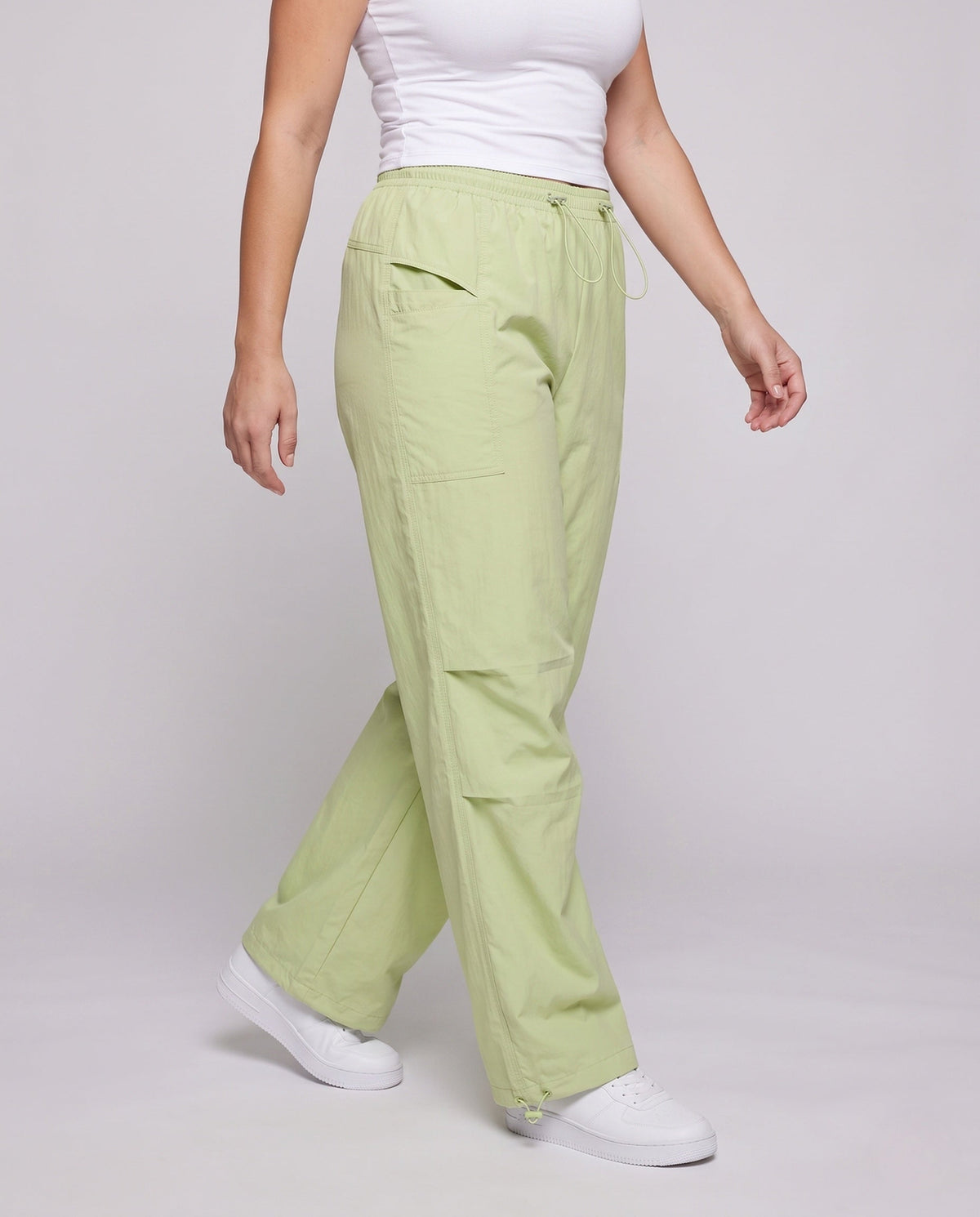 Women's technical cargo pants with adjustable waistband and multifunctional pockets - lower body view