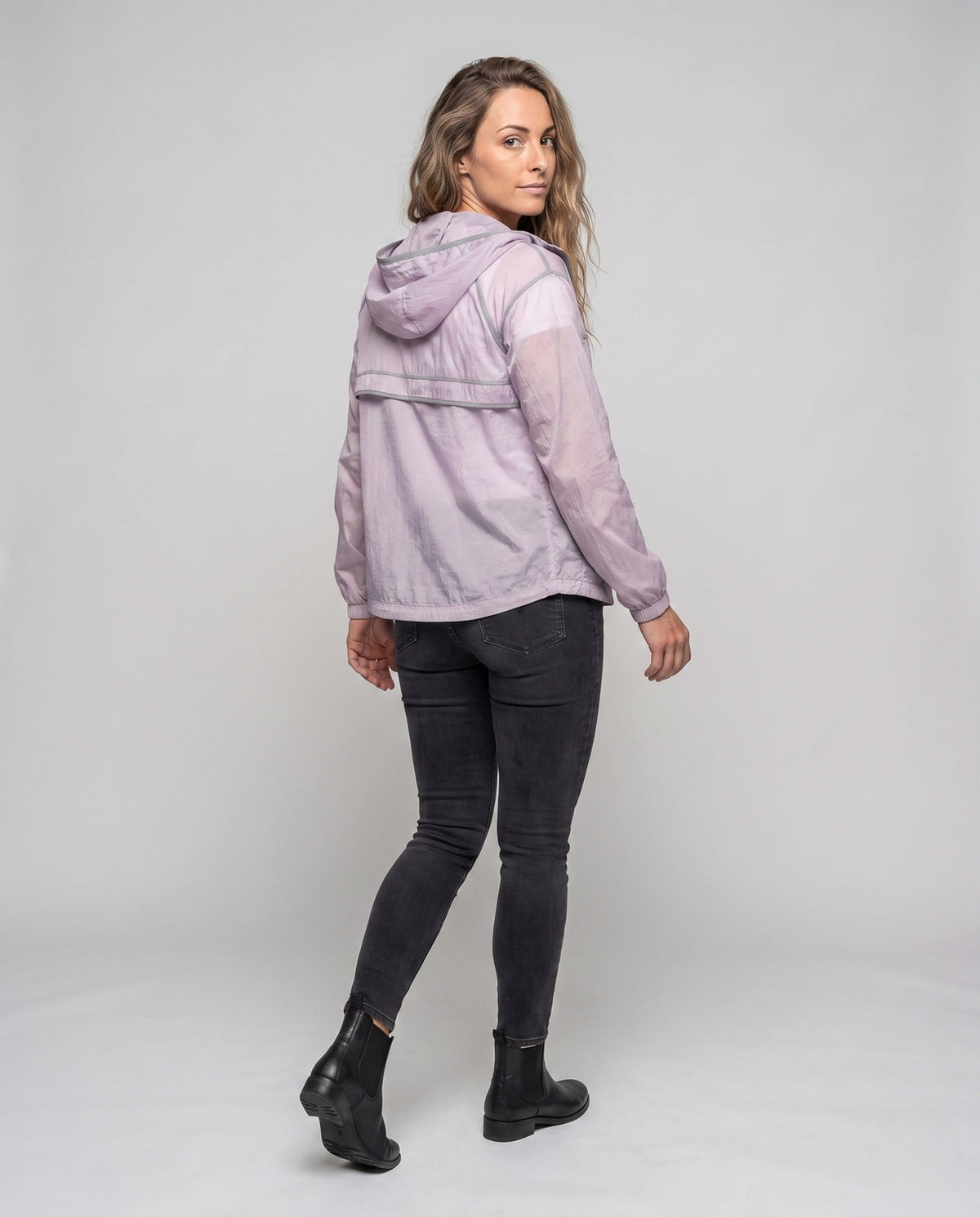 Unisex nan minimalist all-weather outdoor jacket with hood, windproof material, concealed zip pockets, and elastic hem All Fashion - back view