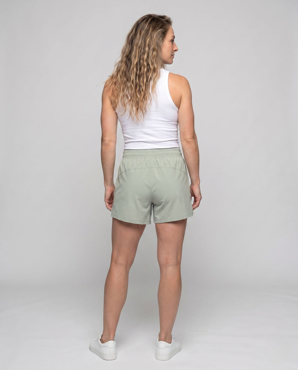 Women's sporty running shorts with elastic waistband and breathable inserts - back view