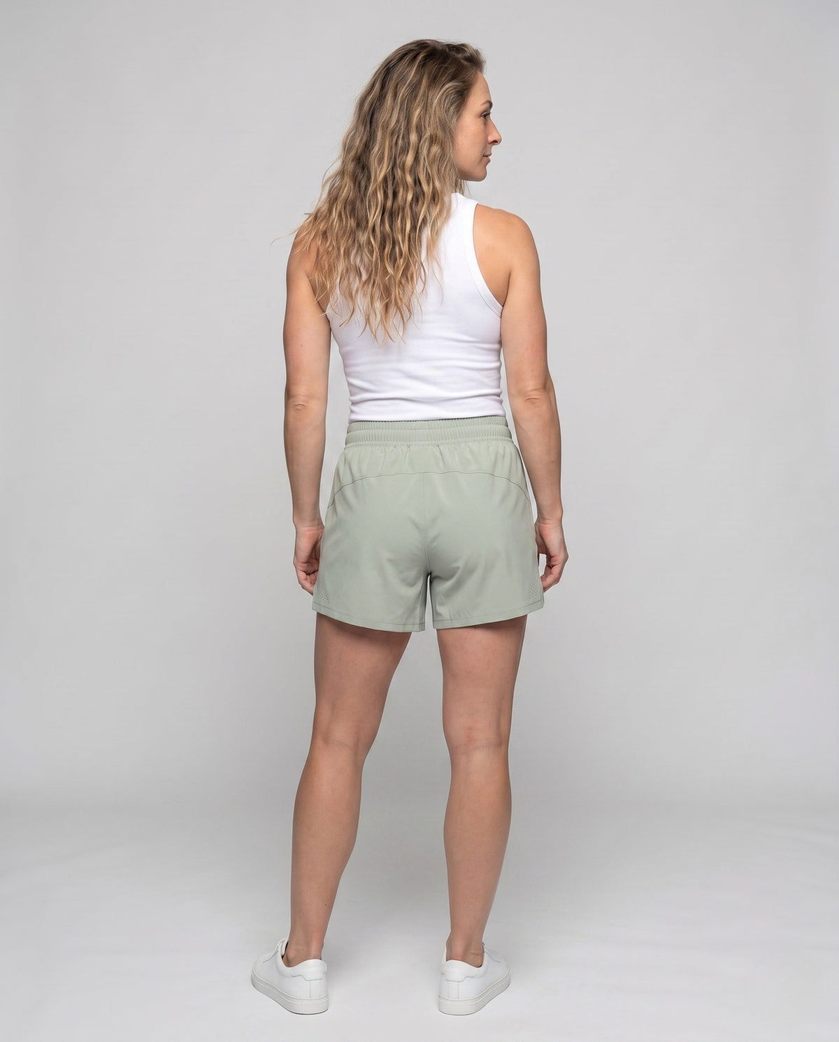 Women's sporty running shorts with elastic waistband and breathable inserts - back view