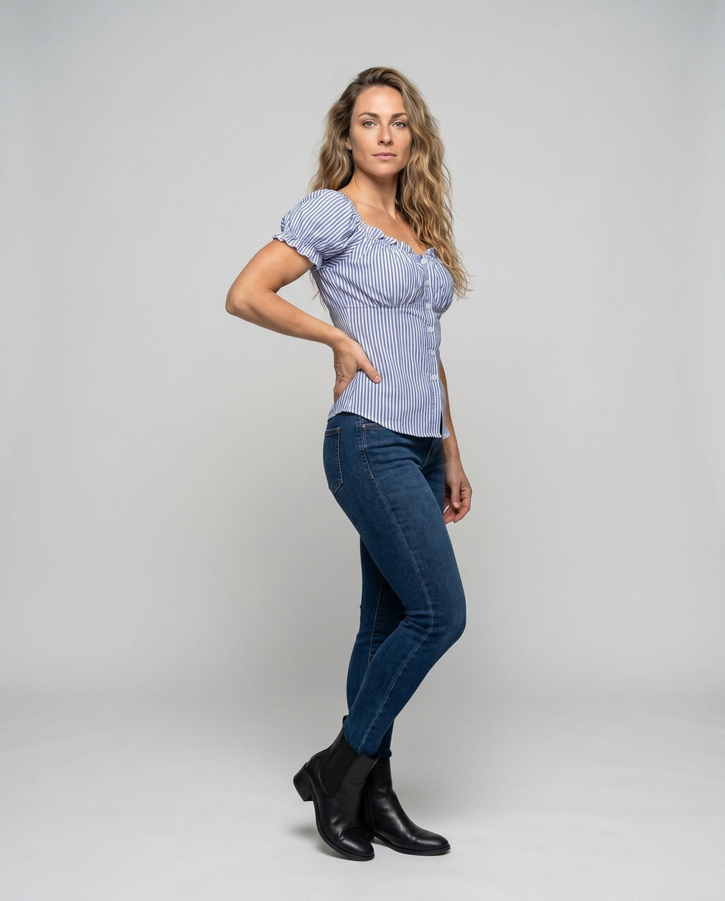 Women's fitted blouse top with ruffle details and button placket - front view