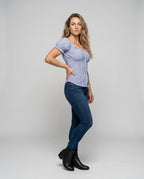 Women's fitted blouse top with ruffle details and button placket - front view